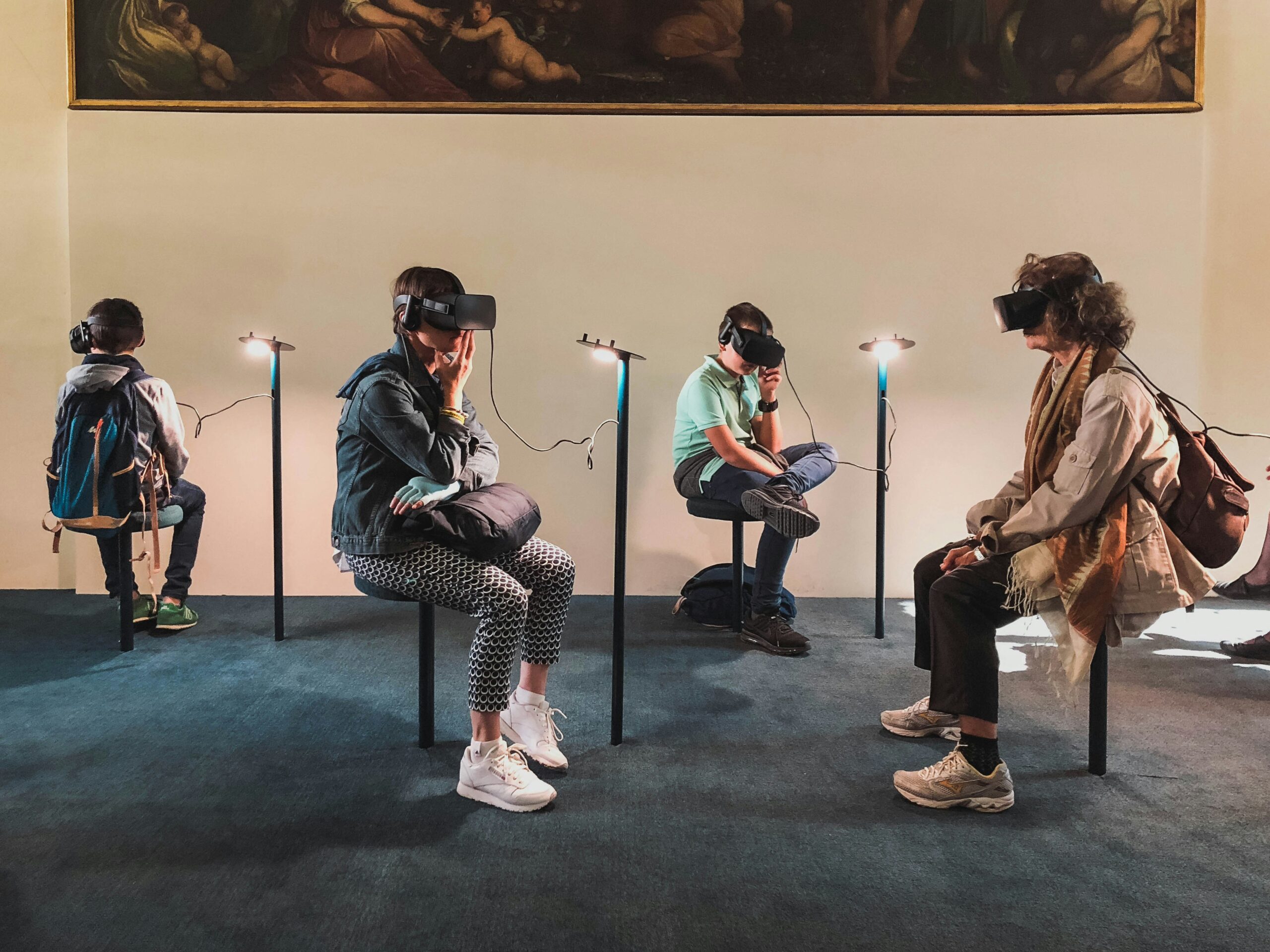 A diverse group of individuals wearing VR headsets while seated in chairs, engaging in virtual reality experiences at a career fair.