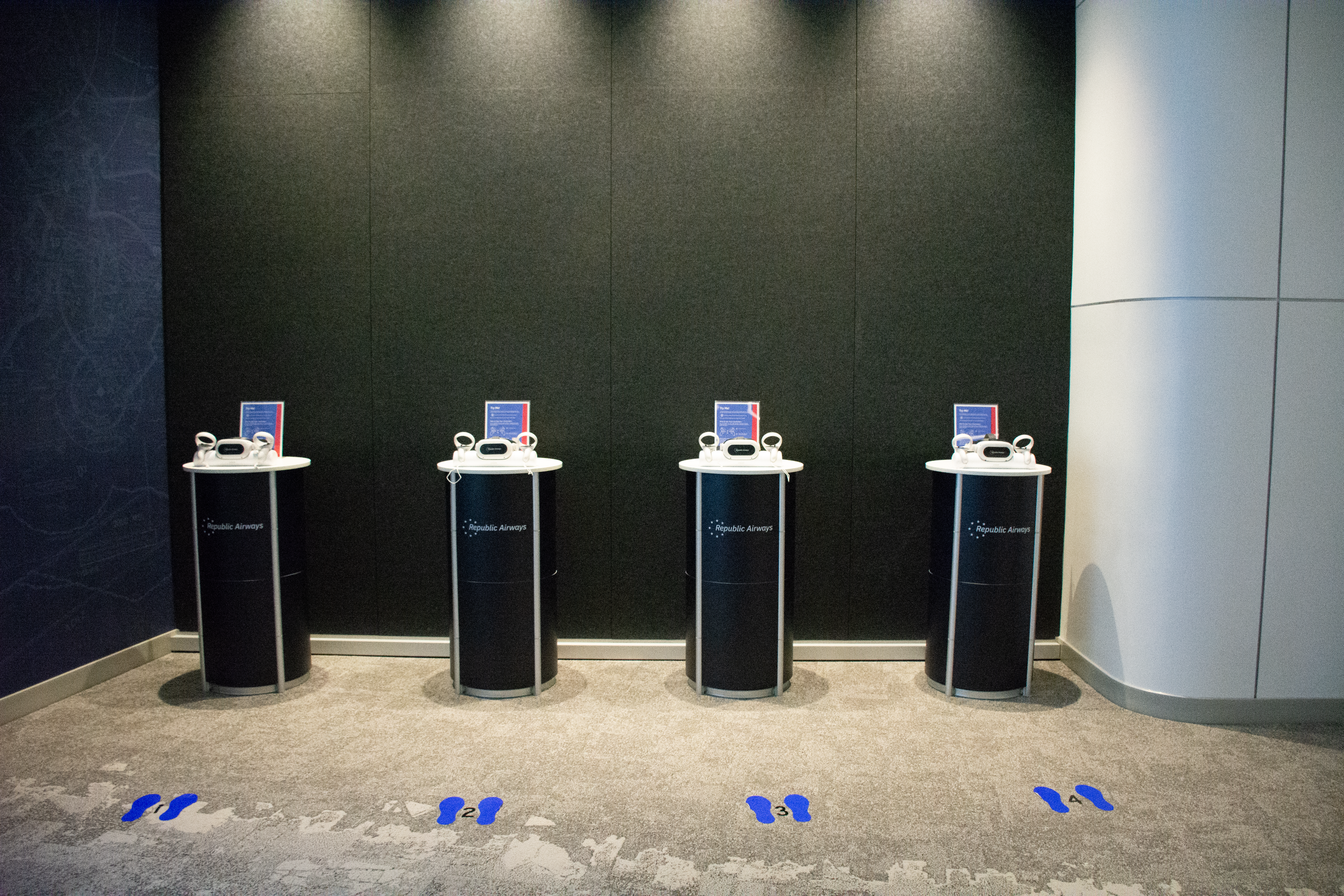 4 Republic Airways kiosks in a community room with VR headsets.